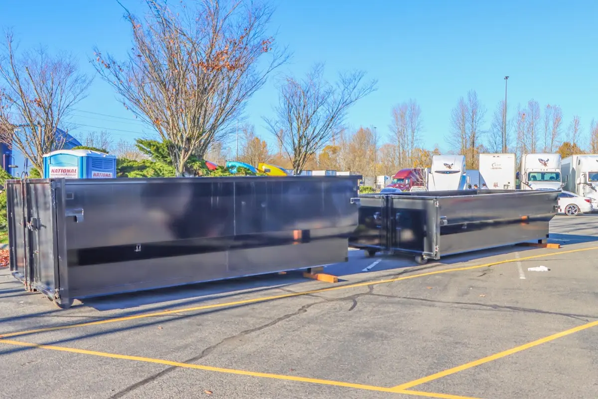 Professional dumpster rental service with roll-off container on residential driveway in Dale City